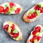 Whipped Ricotta & Tomato Avocado Crostini - a fresh appetizer of crostini with whipped ricotta and feta, topped with marinated tomatoes and avocadoes. | tastythin.com
