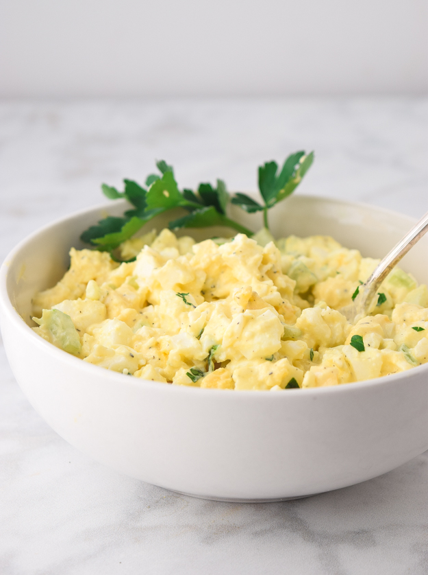 close up of creamy egg salad in a bowl