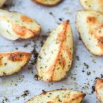greek crispy potato wedges on baking sheet