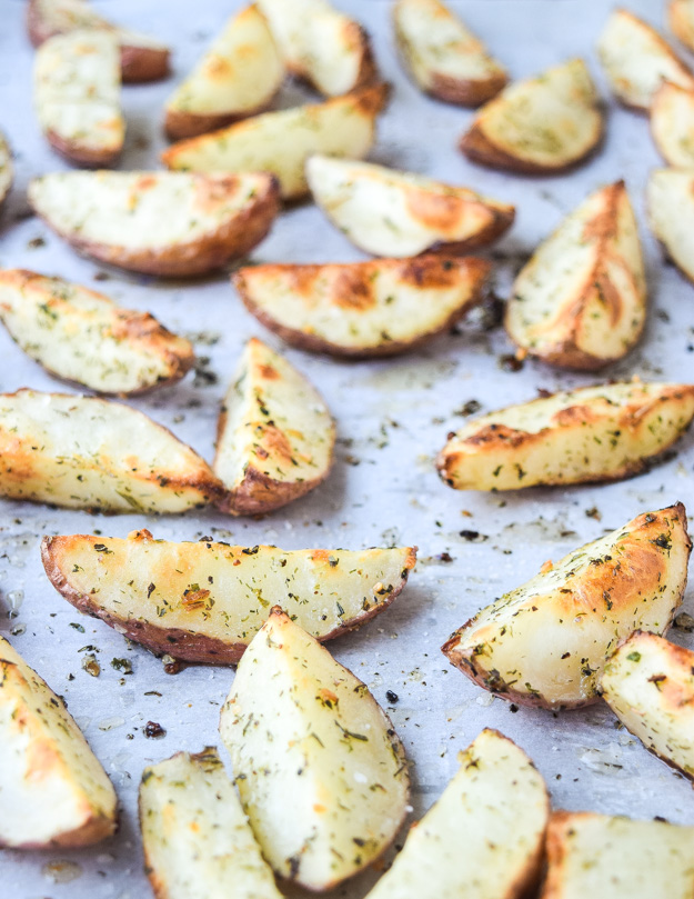 greek crispy potato wedges on baking sheet