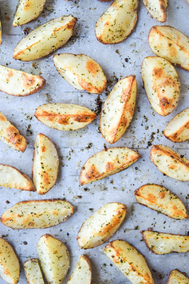 greek crispy potato wedges on baking sheet