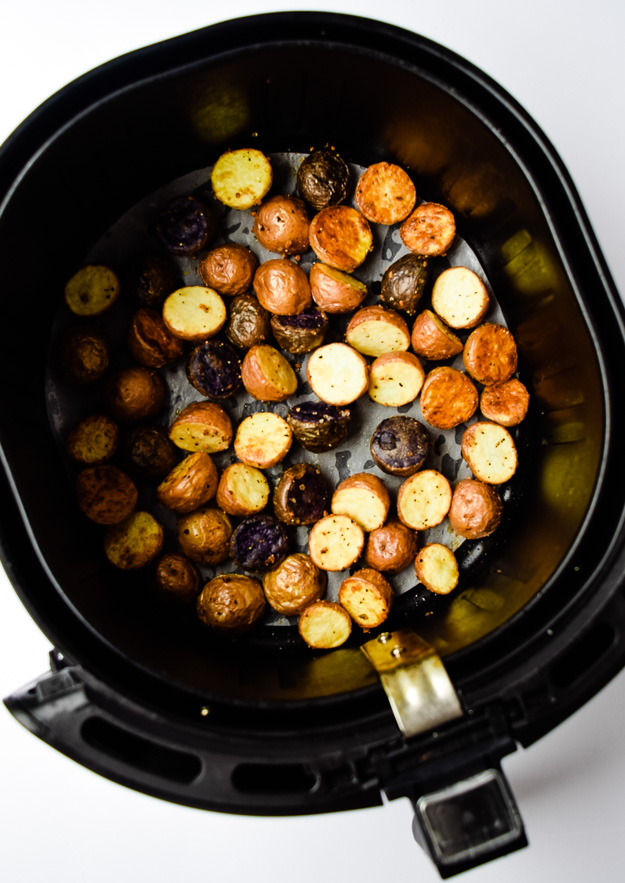 cooked potatoes in basket of air fryer