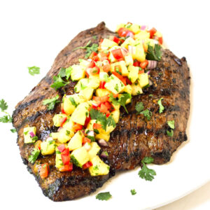 grilled flank steak topped with fresh pineapple salsa