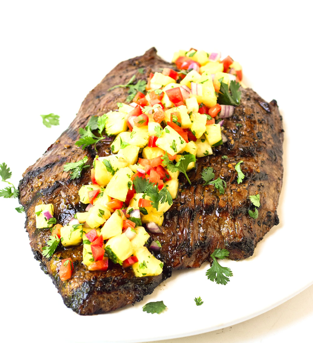 cooked flank steak topped with pineapple salsa