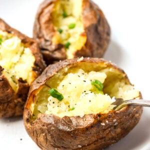 close up of baked potato with crispy skin