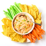 healthy buffalo chicken dip with veggies and tortilla chips