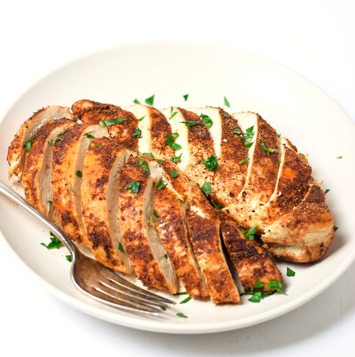 air fryer blackened chicken, sliced on a plate