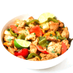 air fryer chicken fajitas in a bowl with lime