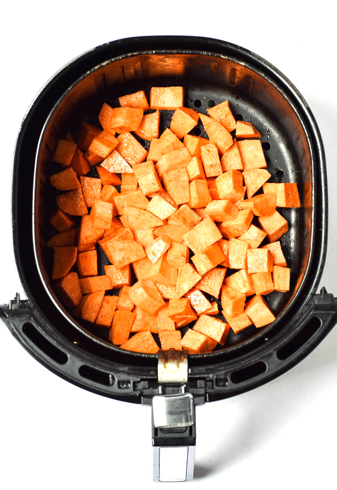 cubed sweet potatoes in air fryer before cooking