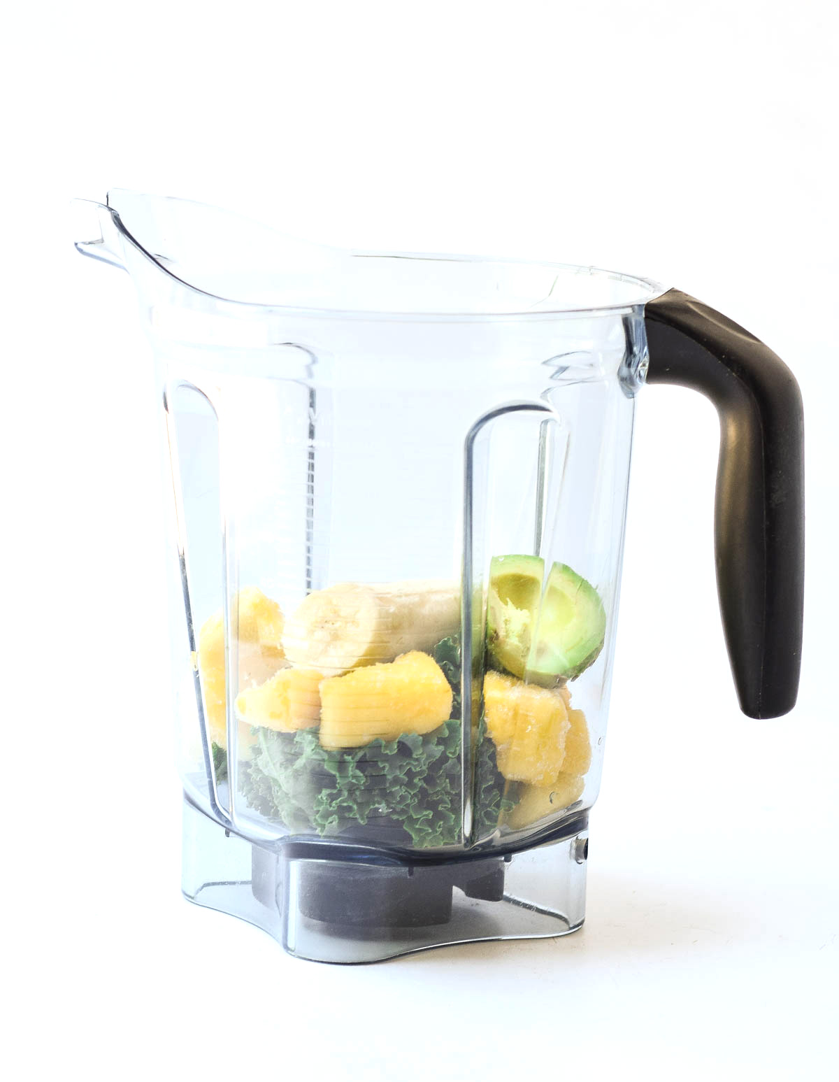 all ingredients for tropical green smoothie in a blender