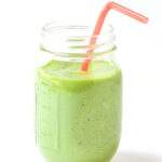 island green tropical smoothie in mason jar with a straw