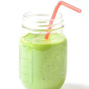 island green tropical smoothie in mason jar with a straw