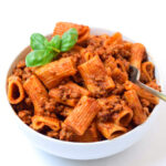 Instant Pot Rigatoni with Meat Sauce in a bowl topped with basil