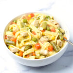 close up of instant pot chicken noodle casserole in a bowl with fork